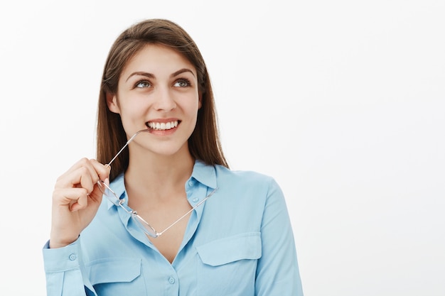 Positive brunette businesswoman posing in the studio