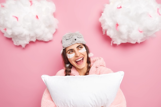 Positive brunette woman dressed in pajama