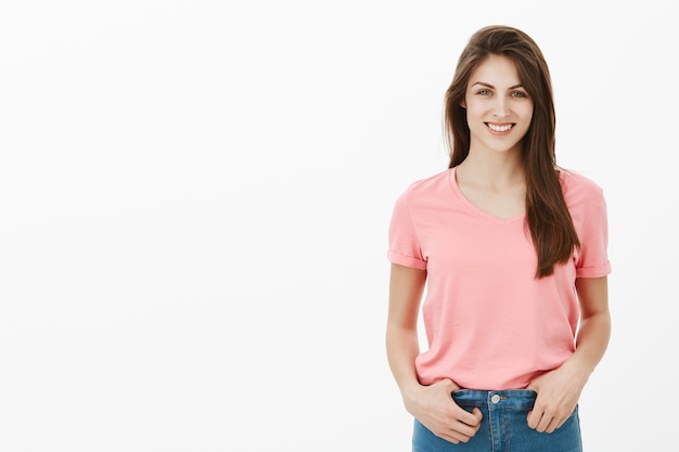 Positive brunette woman posing in the studio