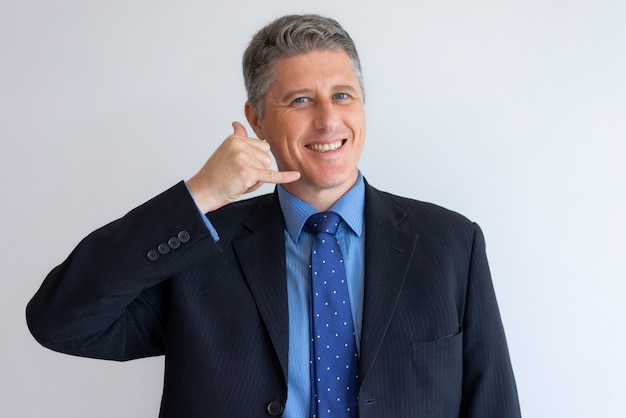 Free photo positive business man gesturing call me