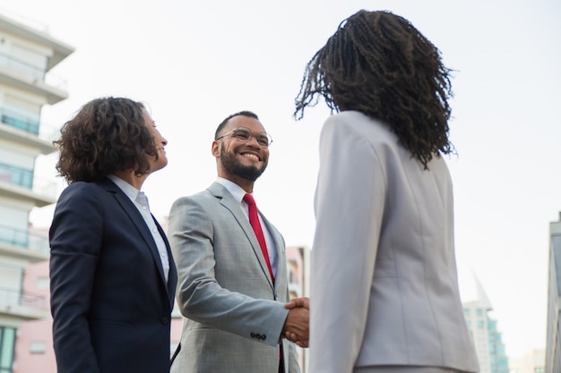 Free photo positive business partners meeting outside