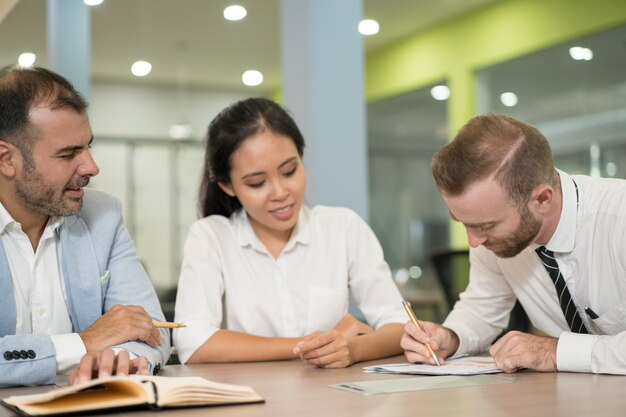 Positive business people working together in office