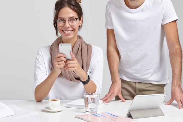 Positive European woman has break after work