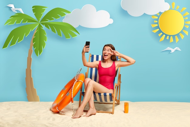 Positive European woman relaxes in deck chair