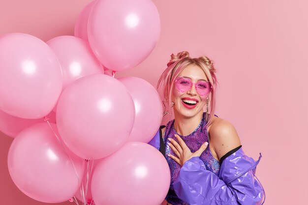 positive fashionable woman expresses sincere emotions smiles broadly feels thankful