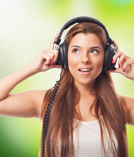 Positive girl listening music in headphones.