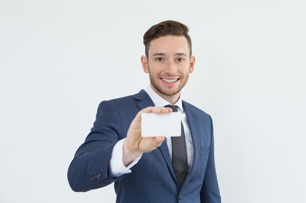 Positive handsome manager showing business card