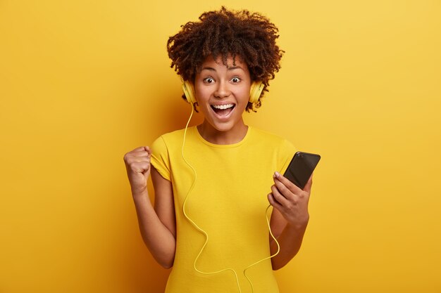 Positive hipster girl listens audio record with high volume