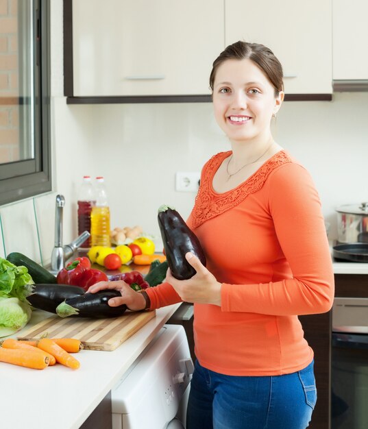 positive housewife cooking eggplants