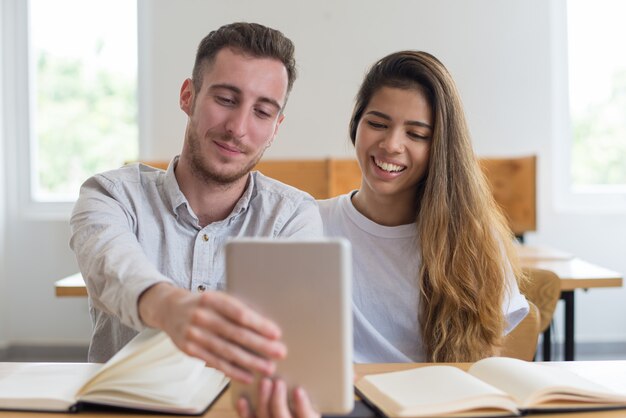 Positive male and female students videoconferencing