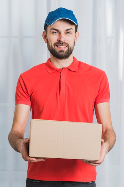 Free photo positive man delivering parcel