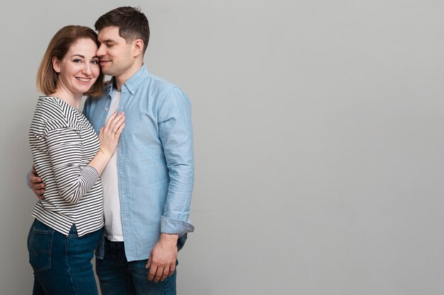 Free photo positive man and woman holding each other