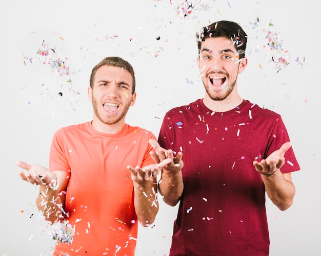 Free photo positive men sprinkling confetti