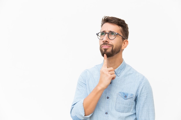 Positive pensive male customer studying special offer