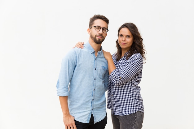 Positive pretty Latin woman hugging boyfriend