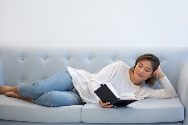 Positive relaxed girl studying her notes