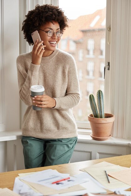 Positive teenager with her phone posing at home