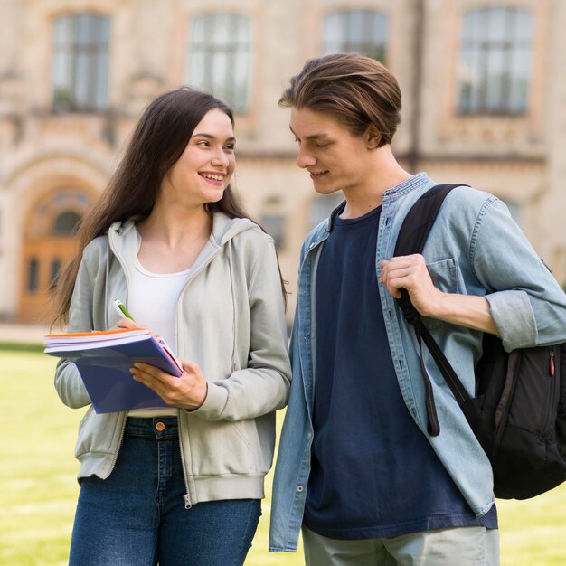 Positive teenagers discussing notes together