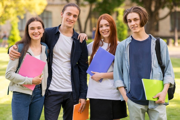 Free photo positive teenagers posing together at university