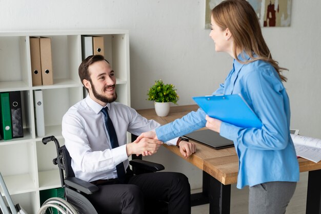 Positive woman and man shaking hands together