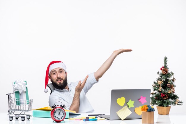 Positive young businessman with santa claus hat working