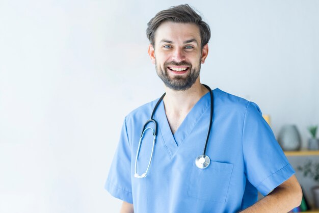 Positive young doctor in scrubs