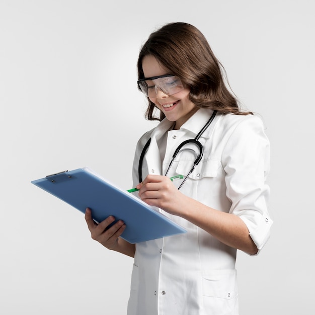 Positive young girl completing medical form