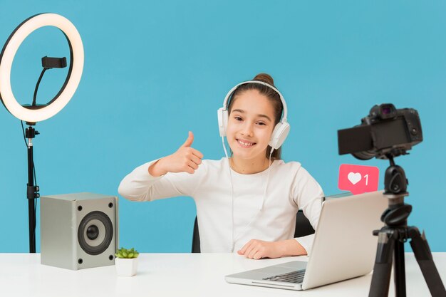 Positive young girl happy to record video