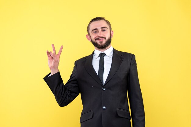 Positive young man showing victory sign