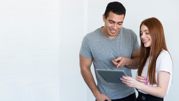 Positive young man and woman working together