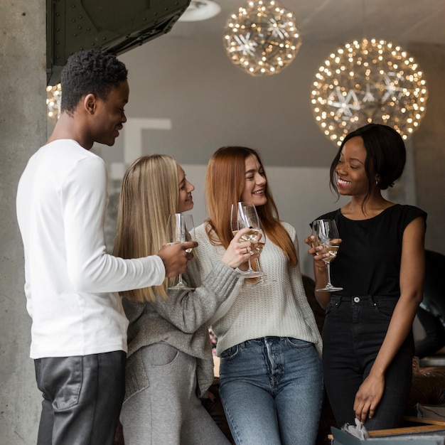 Positive young people having wine together