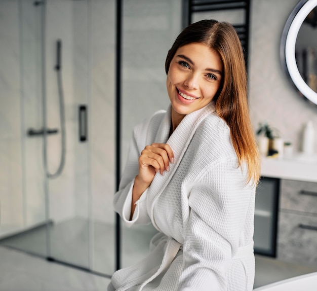 Positive young woman in a bathrobe