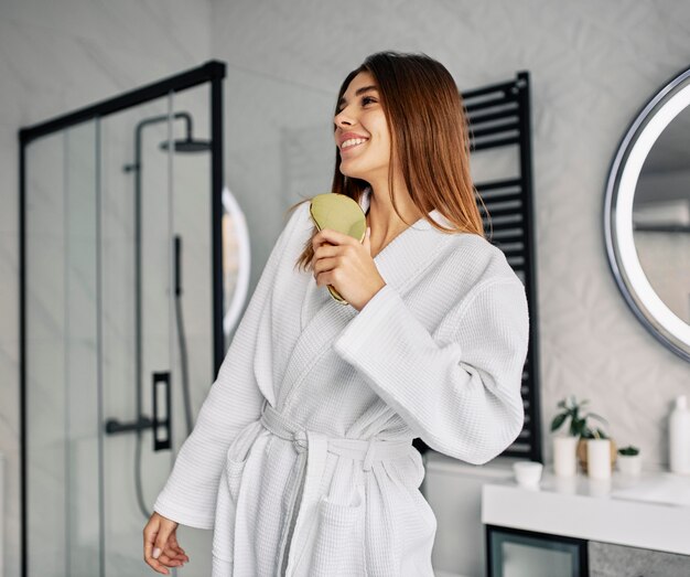 Positive young woman in a bathrobe