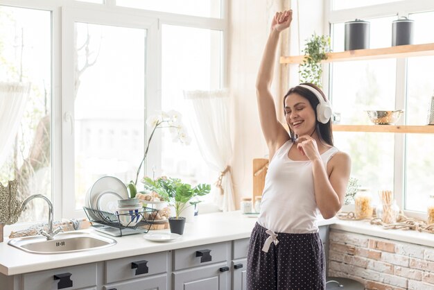 Positive young woman enjoying music