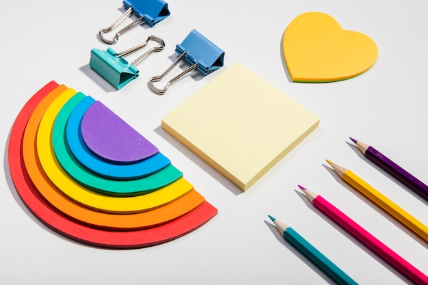 Post-it note cards and school tools and rainbow paper high view