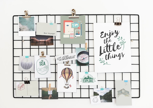 Postcard and Pictures on a Rack Against a White Wall