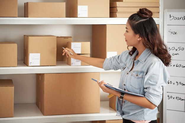 Postwoman working with parcels