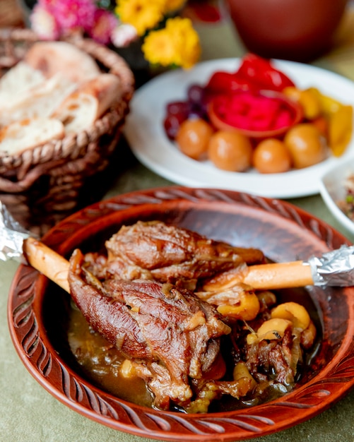 Pot roast meat served with bread and pickles