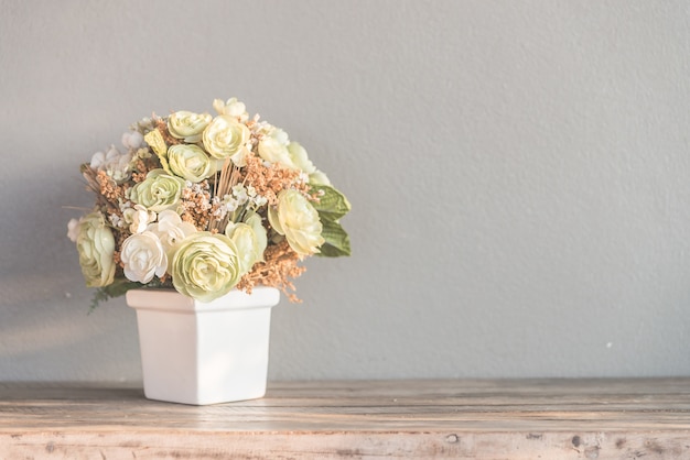 Pot with flowers in pastel colors