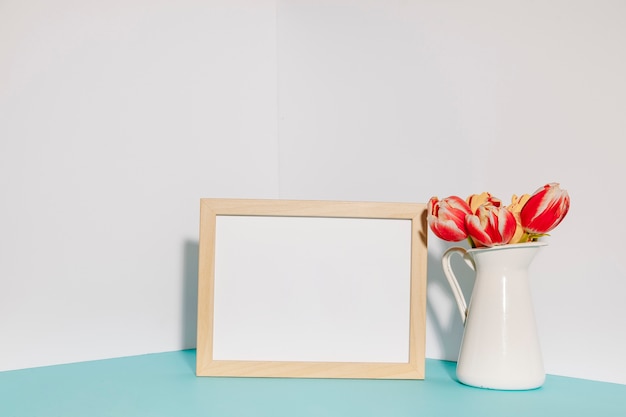 Free photo pot with tulips near empty frame