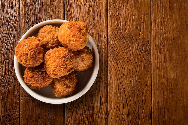 Premium Photo | Potato ball fried portion on the wood background