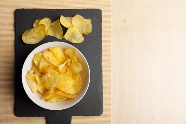 Potato chips in bowl on a table