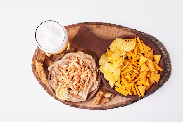 Potato chips with beer on white.