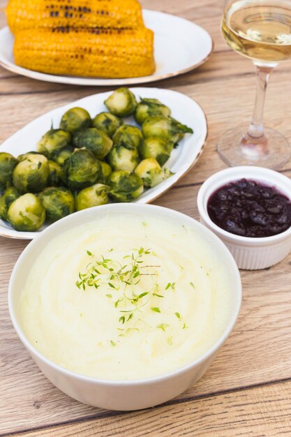 Potato puree in bowl on wooden table