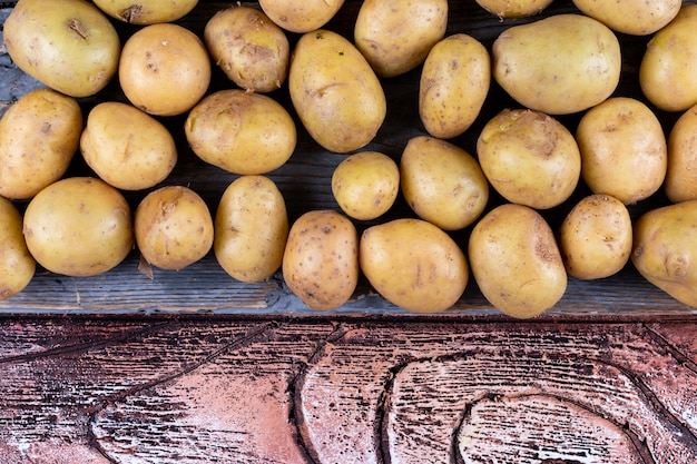 Potatoes on a cloth top view on a wooden table