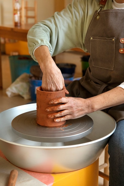 Pottery craftsperson in the studio creating ceramics