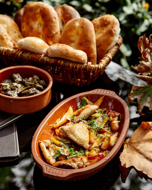 Pottery pan with azerbaijani chicken dish chigirtma with onion and potato