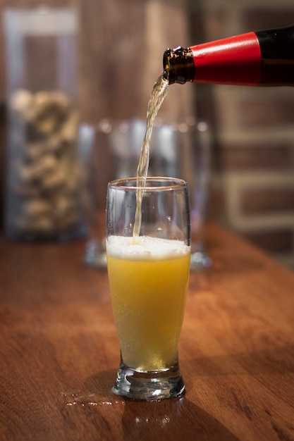 Pouring beer from bottle to pint process