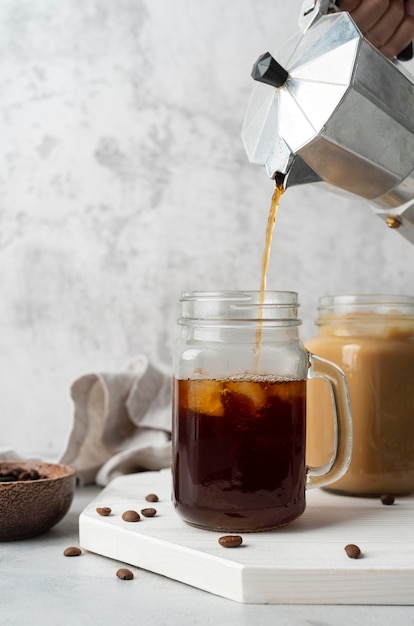 Pouring coffee in mug close up