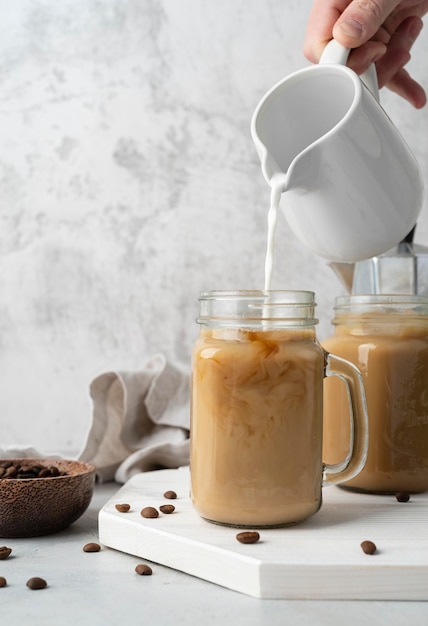 Pouring coffee in mug close up